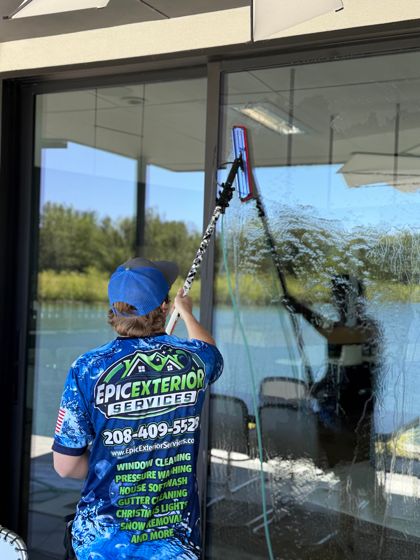 Exterior storefront window cleaning with a water-fed pole brush in the Treasure Valley