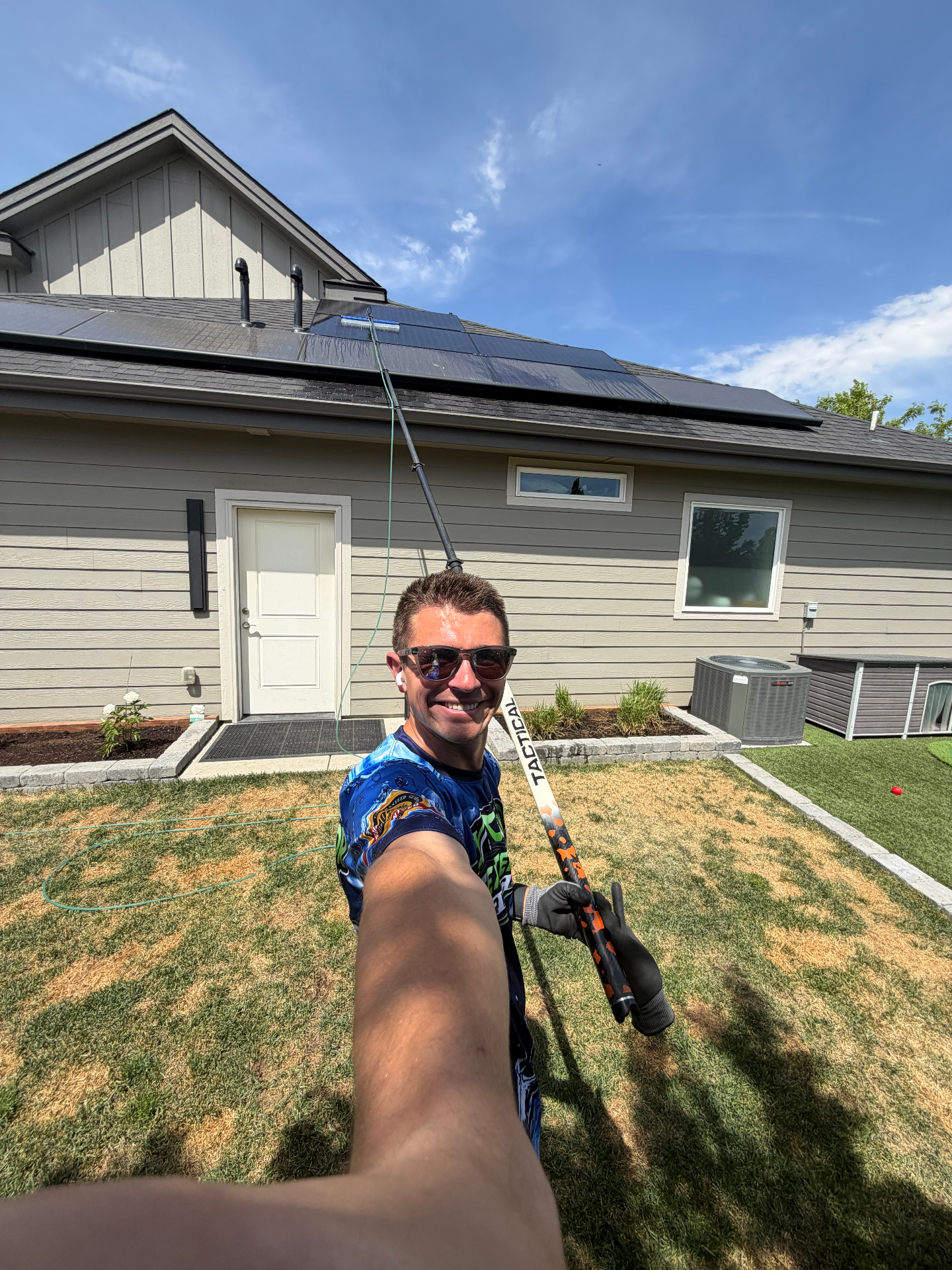 Epic Exterior Services technician cleaning rooftop solar panels with a water-fed pole in Eagle, Idaho