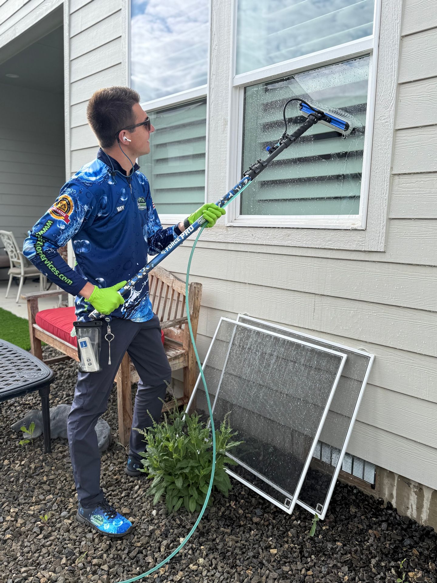 Epic Exterior Services team member cleaning windows