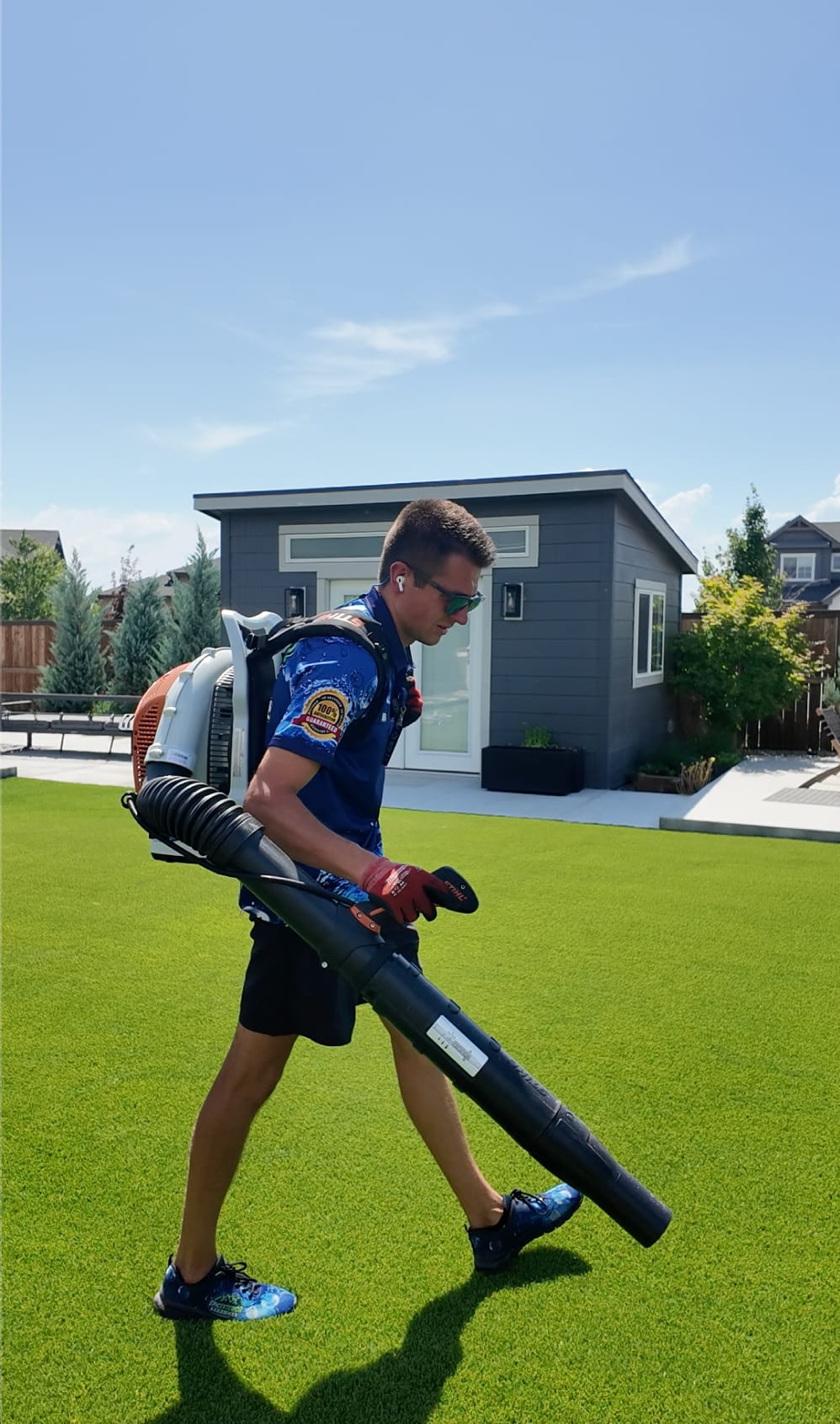 Epic Exterior Services team member cleaning artificial turf in Boise Idaho