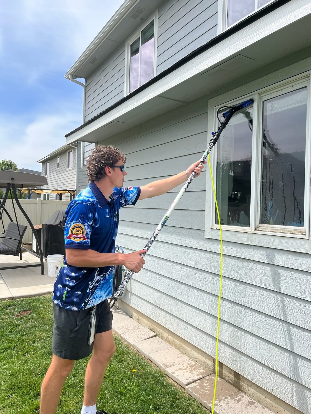 Epic technician cleaning windows with a pure-water pole